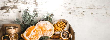 Still life with orange and sea buckthorn on a wooden background, concept of seasonal vitamins and healthy eating.の写真素材