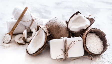Spa still life of organic cosmetics with coconuts on a light wooden background, body care conceptの写真素材