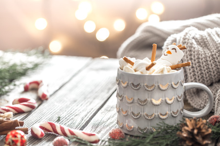 Christmas cocoa concept with marshmallows on a wooden background in a cozy festive atmosphereの写真素材