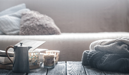 still life from home interior on a wooden background with a small kettle and a beautiful glass, home comfort conceptの写真素材