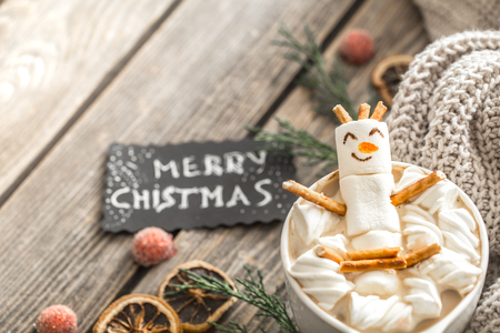 Christmas cocoa concept with marshmallows on a wooden background in a cozy festive atmosphereの写真素材