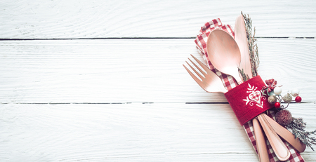 Christmas dinner beautiful cutlery with decor on a white wooden backgroundの写真素材
