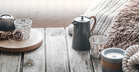 still life from home interior on a wooden background with a candle and pillows, home comfort conceptの写真素材