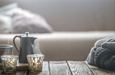 still life from home interior on a wooden background with a small kettle and a beautiful glass, home comfort conceptの写真素材