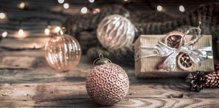 Christmas or New Year festive background, vintage toys on the Christmas tree on a wooden background with a garland with lightsの写真素材