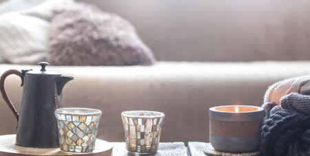 still life from home interior on a wooden background with a small kettle and a beautiful glass, home comfort conceptの写真素材