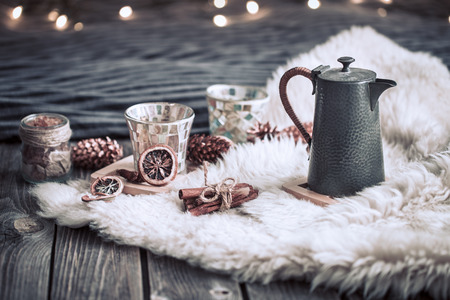Still life home decorations with a teapot on a wooden background in the interior of the room with light in the background, a holiday conceptの写真素材