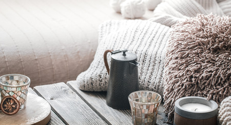 still life from home interior on a wooden background with a candle and pillows, home comfort conceptの写真素材