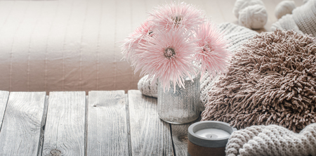 still life from home interior on a wooden background with a candle and pillows, home comfort conceptの写真素材