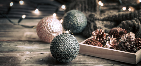 Christmas or New Year festive background, vintage toys on the Christmas tree on a wooden background with a garland with lightsの写真素材