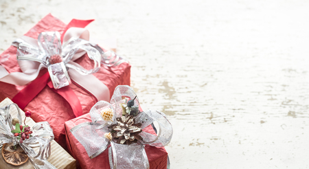 Festive beautiful gift boxes with a bow on a light wooden background.の写真素材