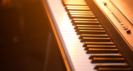 piano keys close-up, on a beautiful colored background, the concept of musical instrumentsの写真素材