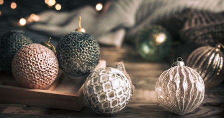 Christmas or New Year festive background, vintage toys on the Christmas tree on a wooden background with a garland with lightsの写真素材