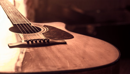 acoustic guitar close-up on a beautiful colored background, the concept of stringed instruments