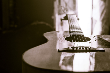 acoustic guitar close-up on a beautiful colored background, the concept of stringed instrumentsの写真素材