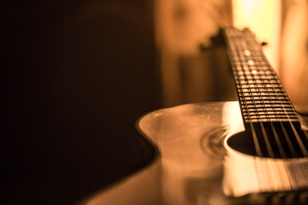 acoustic guitar close-up on a beautiful colored background, the concept of stringed instrumentsの写真素材