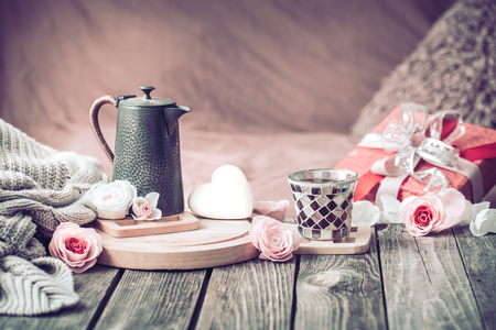 Concept for Valentine's Day or Mother's Day, a festive still life with tea and a teapot on a wooden table in the living room at homeの写真素材