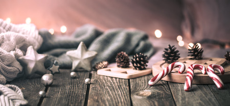 home comfort, details of the festive interior on a wooden table and lights in the backgroundの写真素材