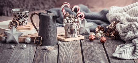 home comfort, details of the festive interior on a wooden table and lights in the backgroundの写真素材