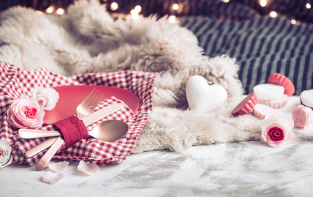 Valentine's Day, festive dinner on a wooden background cutlery in a cozy homely atmosphereの写真素材