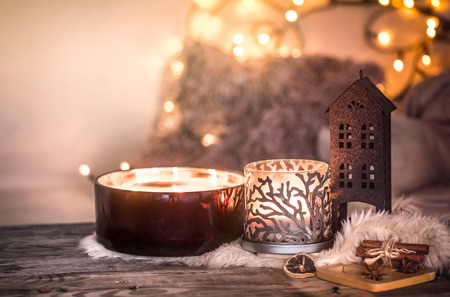home still life in the interior with beautiful candles, on the background of a cozy home decor, the concept of home itemsの写真素材