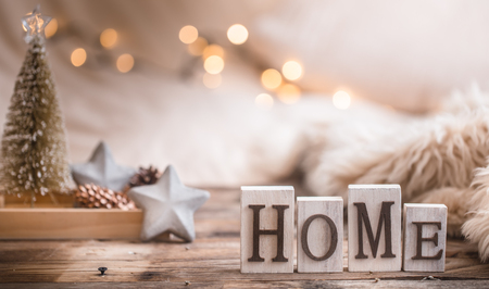 Composition homely festive atmosphere in the interior with home decor items and wooden letters with the words home, the concept of comfort and cozinessの写真素材