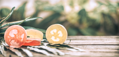 Spa handmade soap, composition on tropical leaves, wooden background with space for text, Spa concept and relaxation for the bodyの写真素材
