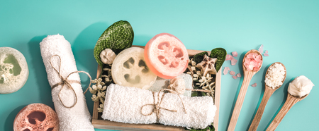 Organic Spa cosmetics, composition with soap and Spa care items on blue background with tropical leaf, Spa and body care conceptの写真素材