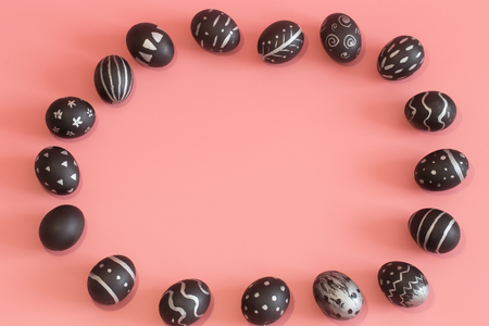 The Easter egg is black with light pattern and creative handmade , colorful pink background , the concept of the Easter holidaysの写真素材