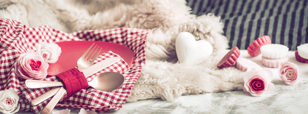 Valentine's Day, festive dinner on a wooden background cutlery in a cozy homely atmosphereの写真素材