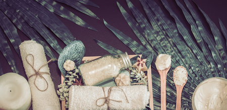 Spa composition on a dark background in a wooden box with a tropical leaf, Spa and body care conceptの写真素材
