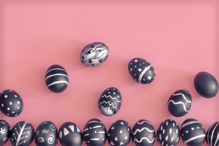 The Easter egg is black with light pattern and creative handmade , colorful pink background , the concept of the Easter holidaysの写真素材
