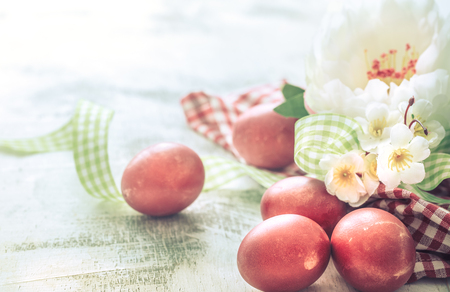 Easter background with red egg with flowers, the bright interior, the concept of the Easter holidaysの写真素材
