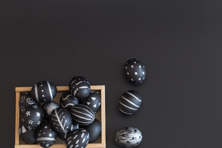 Easter eggs black and white handmade pattern in wooden box isolated on black background, Easter holidays conceptの写真素材