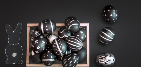 Easter eggs black and white handmade pattern in wooden box isolated on black background, Easter holidays conceptの写真素材