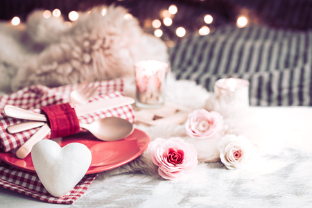 Valentine's Day, festive dinner on a wooden background cutlery in a cozy homely atmosphereの写真素材