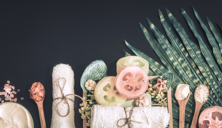 Spa composition on a dark background in a wooden box with a tropical leaf, Spa and body care conceptの写真素材