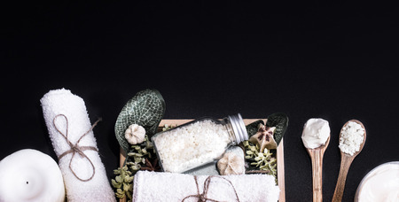 Spa composition on a dark background in a wooden box with a tropical leaf, Spa and body care conceptの写真素材