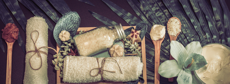 Spa composition on a dark background in a wooden box with a tropical leaf, Spa and body care conceptの写真素材