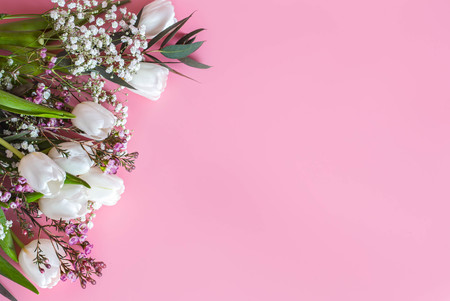 spring flower arrangement with white tulips on a pink background, space for textの写真素材