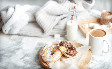 morning breakfast with delicious donuts and coffee at home by the windowの写真素材