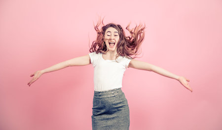 Portrait of a young girl with long hair on a colored background, space for text