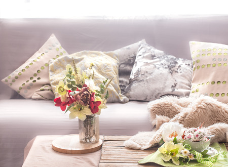 Homely cozy spring interior in the living room with a vase and flowers, home comfort conceptの写真素材