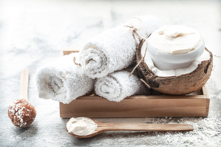 Spa still life with fresh coconut and body care products on light background, spa therapy conceptの写真素材