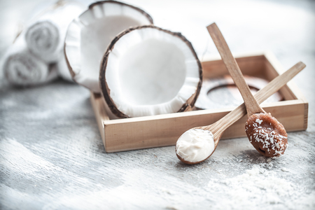 Spa still life with fresh coconut and body care products on light background, spa therapy conceptの写真素材