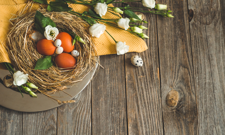 Happy Easter background. Easter eggs in a nest on a metal plate on a wooden background. Quail eggs. Happy Easter conceptの写真素材