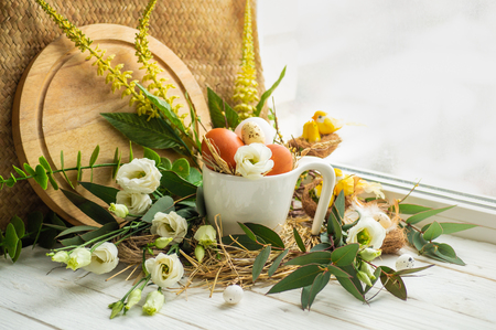Happy Easter background. Easter egg in a nest with floral decoration near the window. Quail eggs. Happy Easter concept.の写真素材