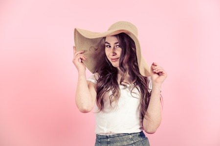 Portrait of a young girl with long hair on a colored background, space for textの写真素材