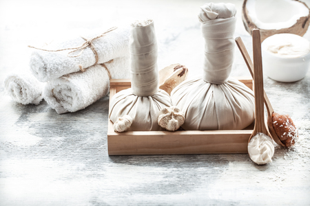 Spa still life with fresh coconut and body care products on light background, spa therapy conceptの写真素材