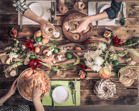 Home Celebration of friends or family at the festive Easter table with Easter cake, top view, celebration Conceptの写真素材
